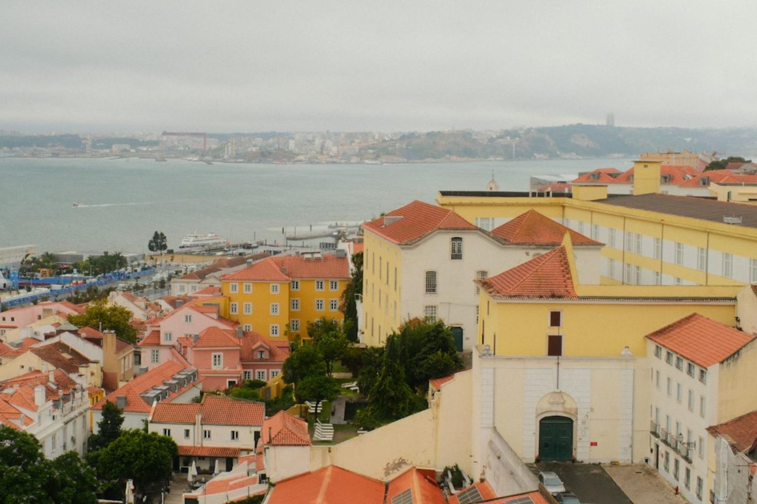 Alfama narrow streets with tile facades and river views in Lisbon