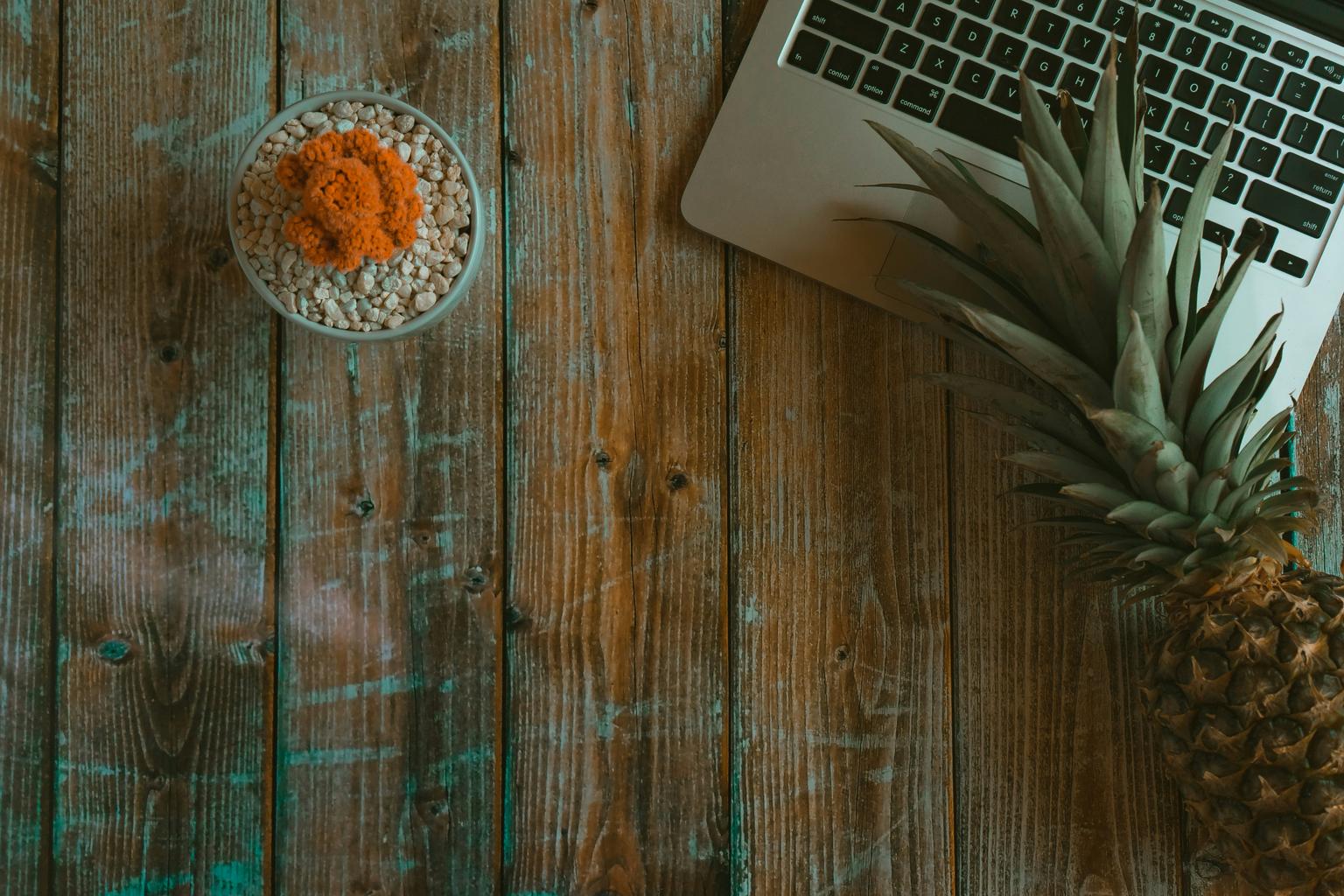 person working remotely on laptop with world map overlay